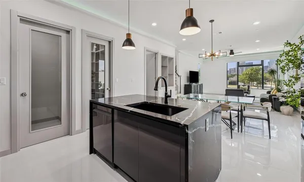 a kitchen with stainless steel appliances granite countertop a sink a stove and a refrigerator