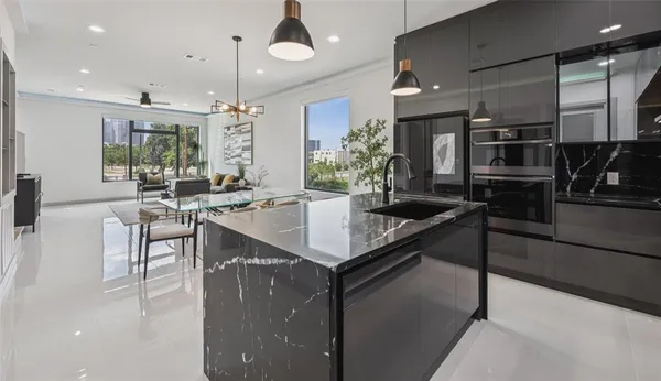 a kitchen with granite countertop a stove and cabinets