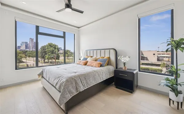 a large bed sitting in a bedroom next to a window