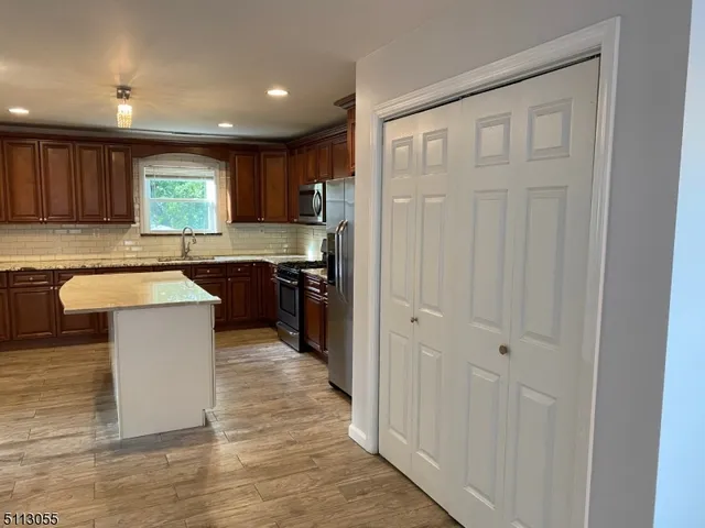 a kitchen with wooden cabinets and sink