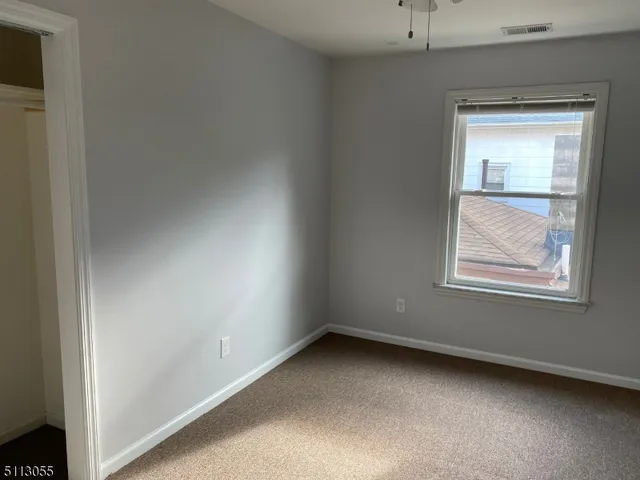an empty room with windows and closet