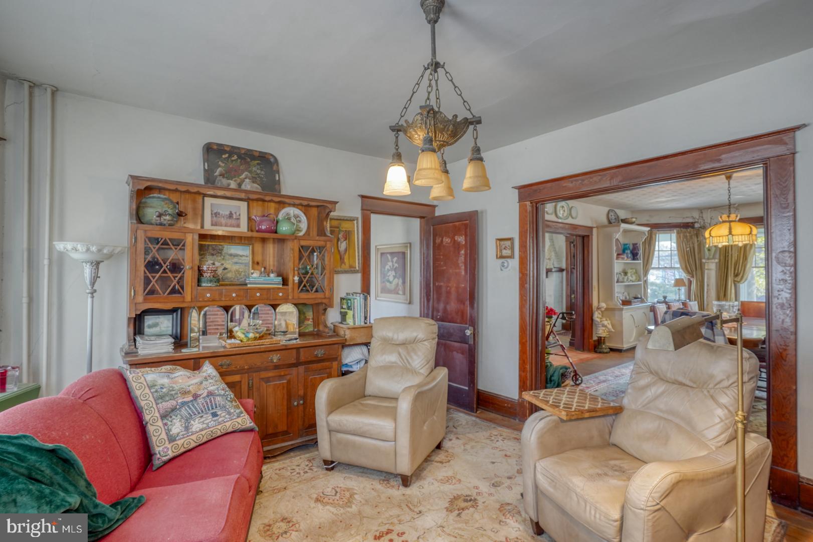 4096 Main Street Trappe, MD 21673 - Photo 30 of 70 a living room with furniture a chandelier and a large window