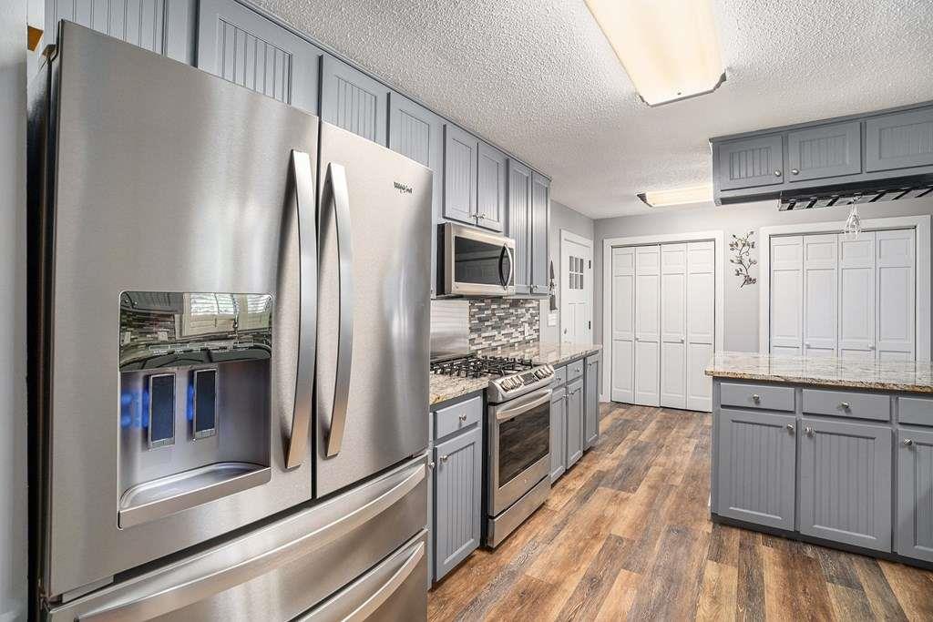370 Davis Road Blue Ridge, GA 30513 - Photo 13 of 47 a kitchen with a refrigerator sink and stainless steel appliances