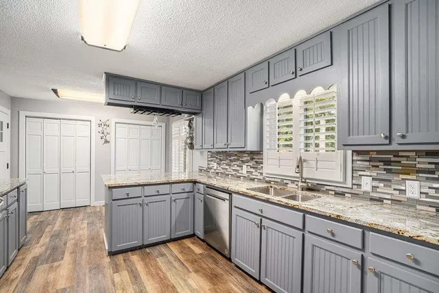 a kitchen with a sink window and cabinets