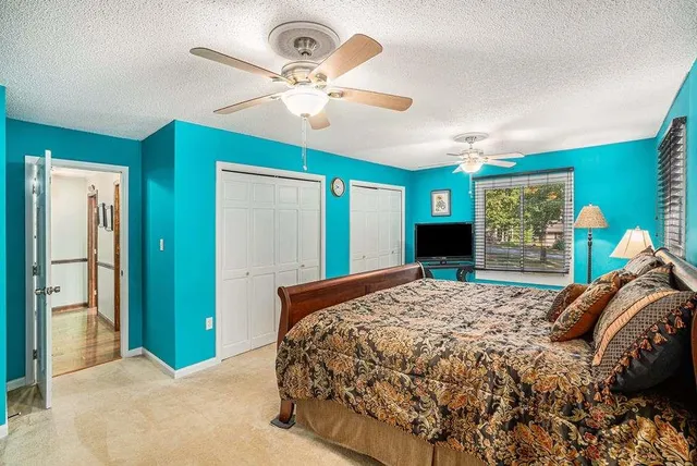 a bedroom with a bed and a chandelier