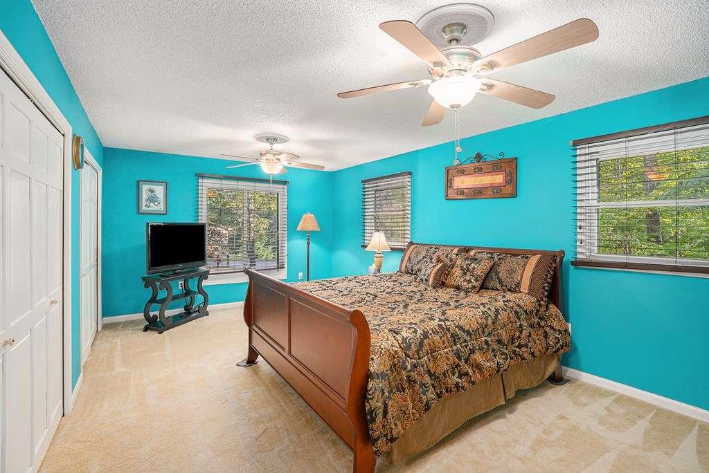 370 Davis Road Blue Ridge, GA 30513 - Photo 22 of 47 a bed sitting in a bedroom next to a window