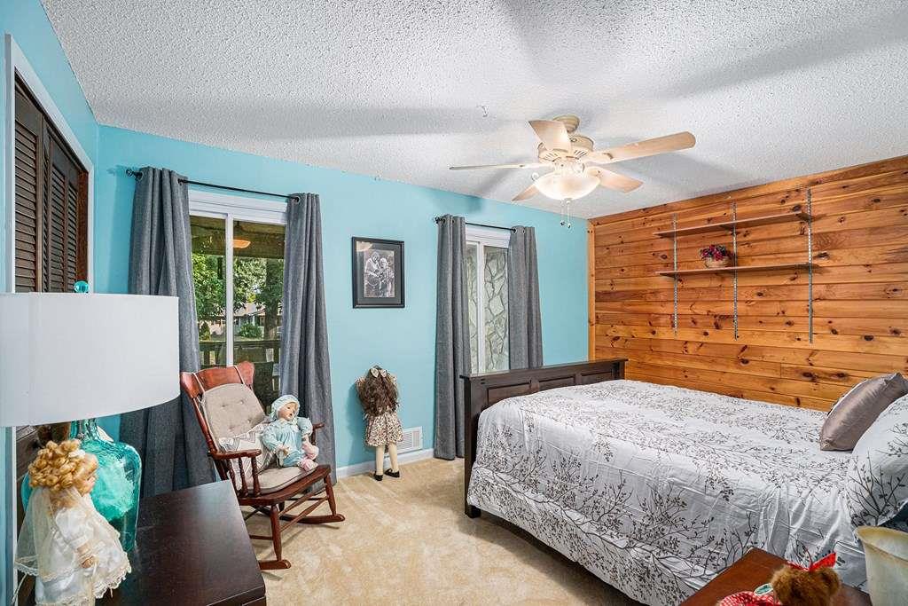 370 Davis Road Blue Ridge, GA 30513 - Photo 24 of 47 a bedroom with a bed and ceiling fan