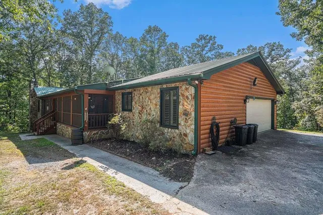 a view of a house with backyard and sitting area