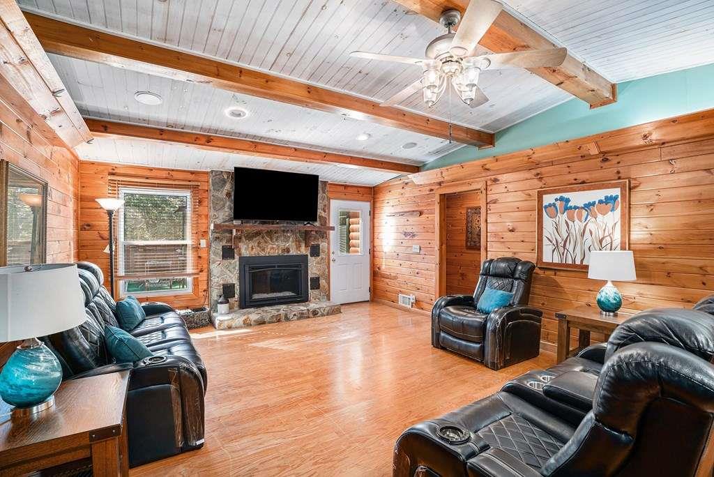 370 Davis Road Blue Ridge, GA 30513 - Photo 6 of 47 a living room with furniture a fireplace and a flat screen tv