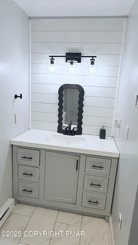 a bathroom with a sink and two mirror