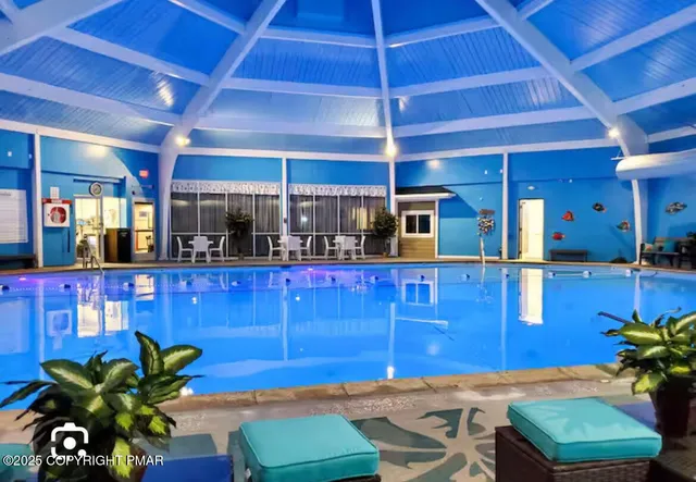 a view of a backyard with swimming pool