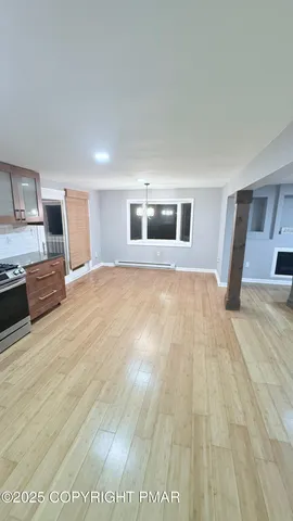 a view of kitchen with sink and natural light