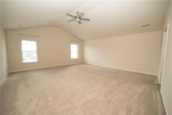 an empty room with windows and ceiling fan view