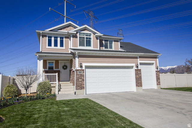 3250 West 1075th Street North Layton, UT 84041 - Photo 1 of 1 View of front of property featuring brick siding, driveway, covered porch, and a garage
