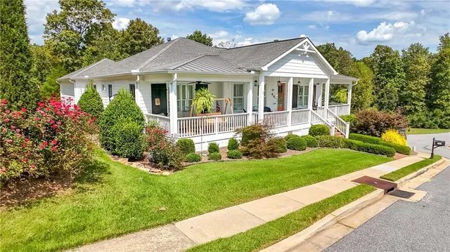 a front view of a house with a yard and porch