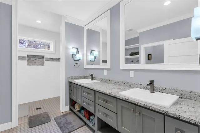 a bathroom with a granite countertop sink and a mirror