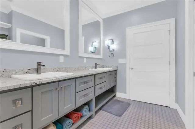 a spacious bathroom with a granite countertop sink and a mirror