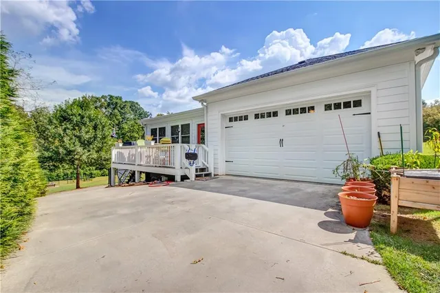 a view of a patio with table and chairs and potted plants