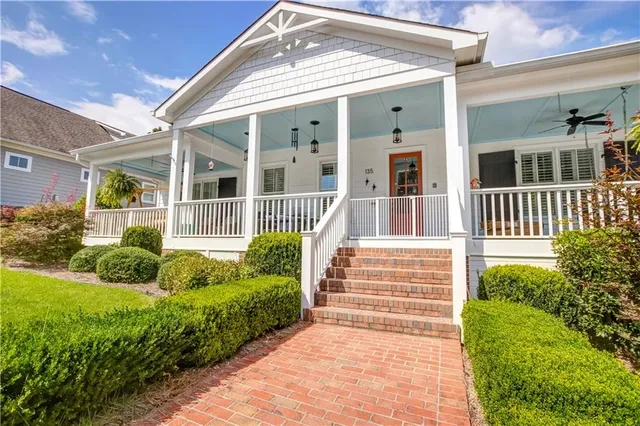 a front view of a house with a garden and plants