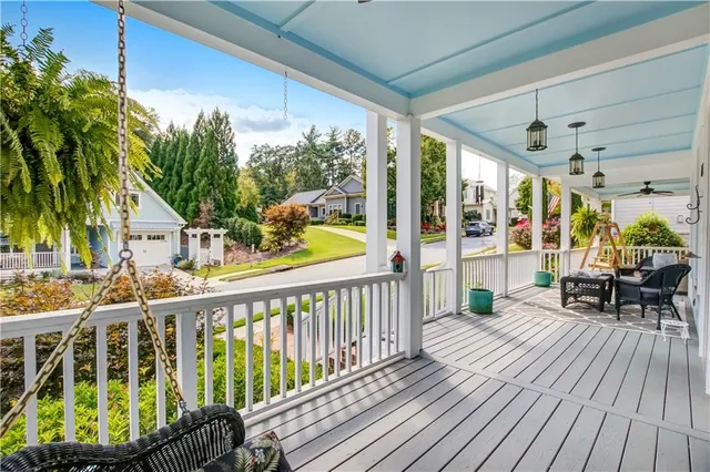 a view of a house with a porch and furniture