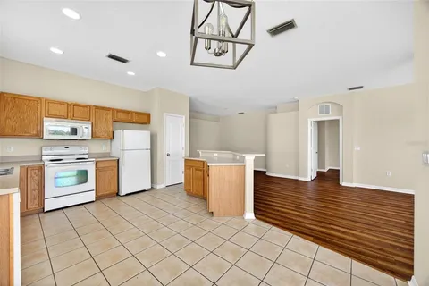 a kitchen with a stove and white cabinets