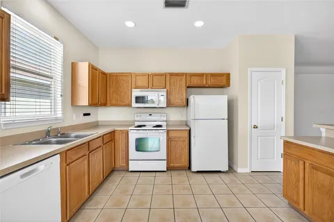 a kitchen with a stove a sink and a refrigerator