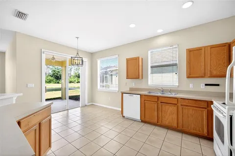 a large kitchen with a window and cabinets
