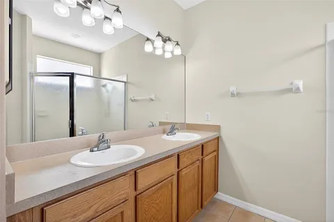 a bathroom with a sink vanity granite and a mirror