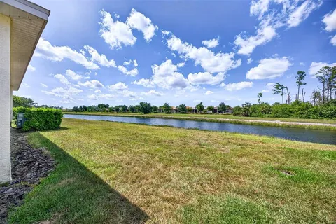 a view of a lake with houses in the back