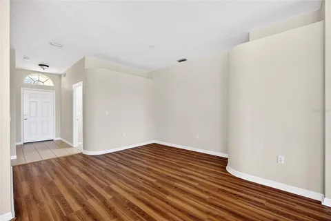 a view of a room with wooden floor