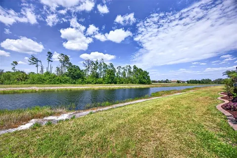 a view of a lake with houses in the back