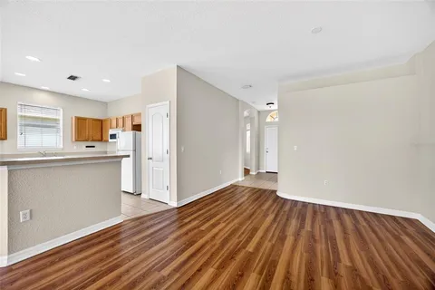 a view of kitchen with wooden floor and electronic appliances