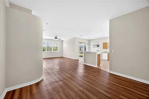 a view of a kitchen with wooden floor and a kitchen