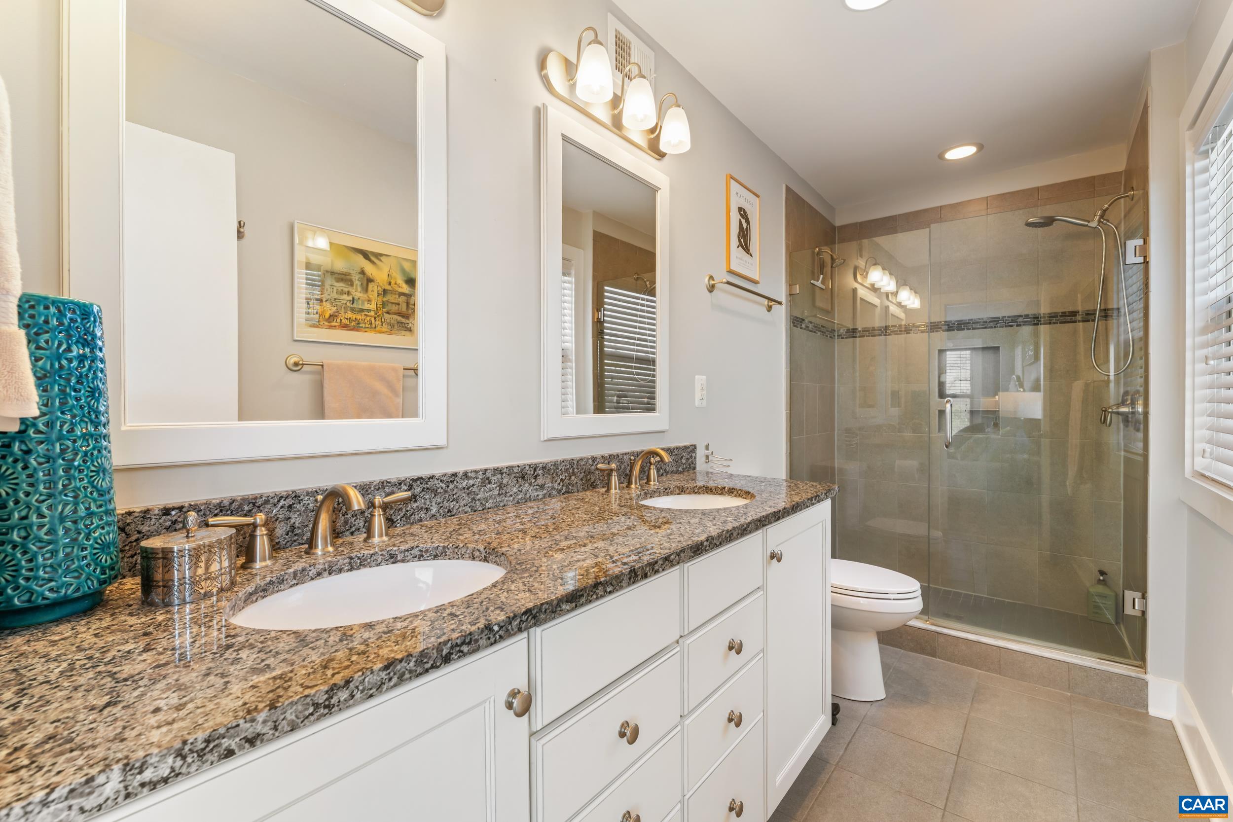 137 Almere Avenue Charlottesville, VA 22902 - Photo 16 of 36 a bathroom with a granite countertop sink a toilet a mirror and shower