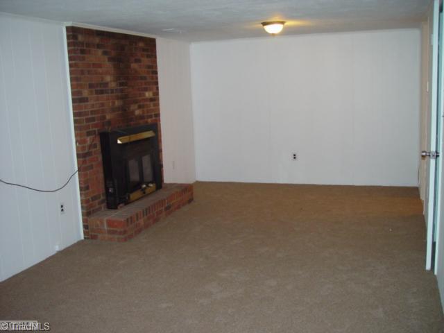 1610 Hauser Road Lewisville, NC 27023 - Photo 9 of 16 Den/Family/Great Room. Playroom with fireplace and woodstove