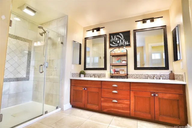 a bathroom with a sink a vanity a mirror and a glass door shower