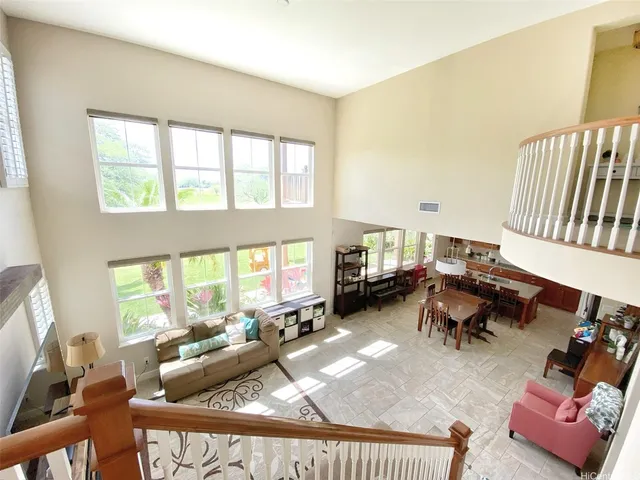 a living room with furniture fireplace and a large window