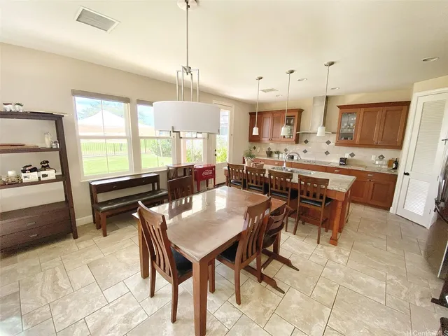 a large kitchen with a table and chairs