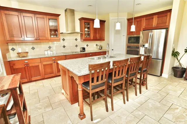 a kitchen with stainless steel appliances granite countertop a sink and a refrigerator