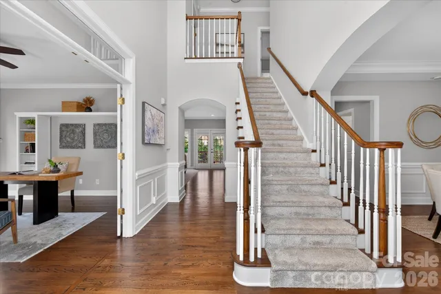 a view of entryway and hall with wooden floor