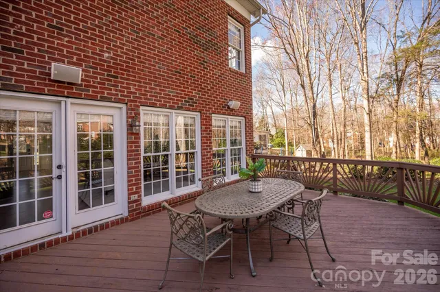 a view of a patio with a table and chairs next to a large window