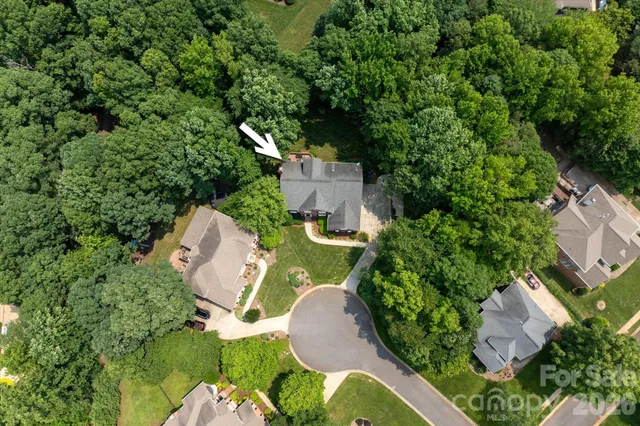 an aerial view of a house with a yard and garden