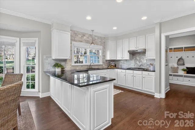a kitchen with granite countertop kitchen island wooden cabinets and center island