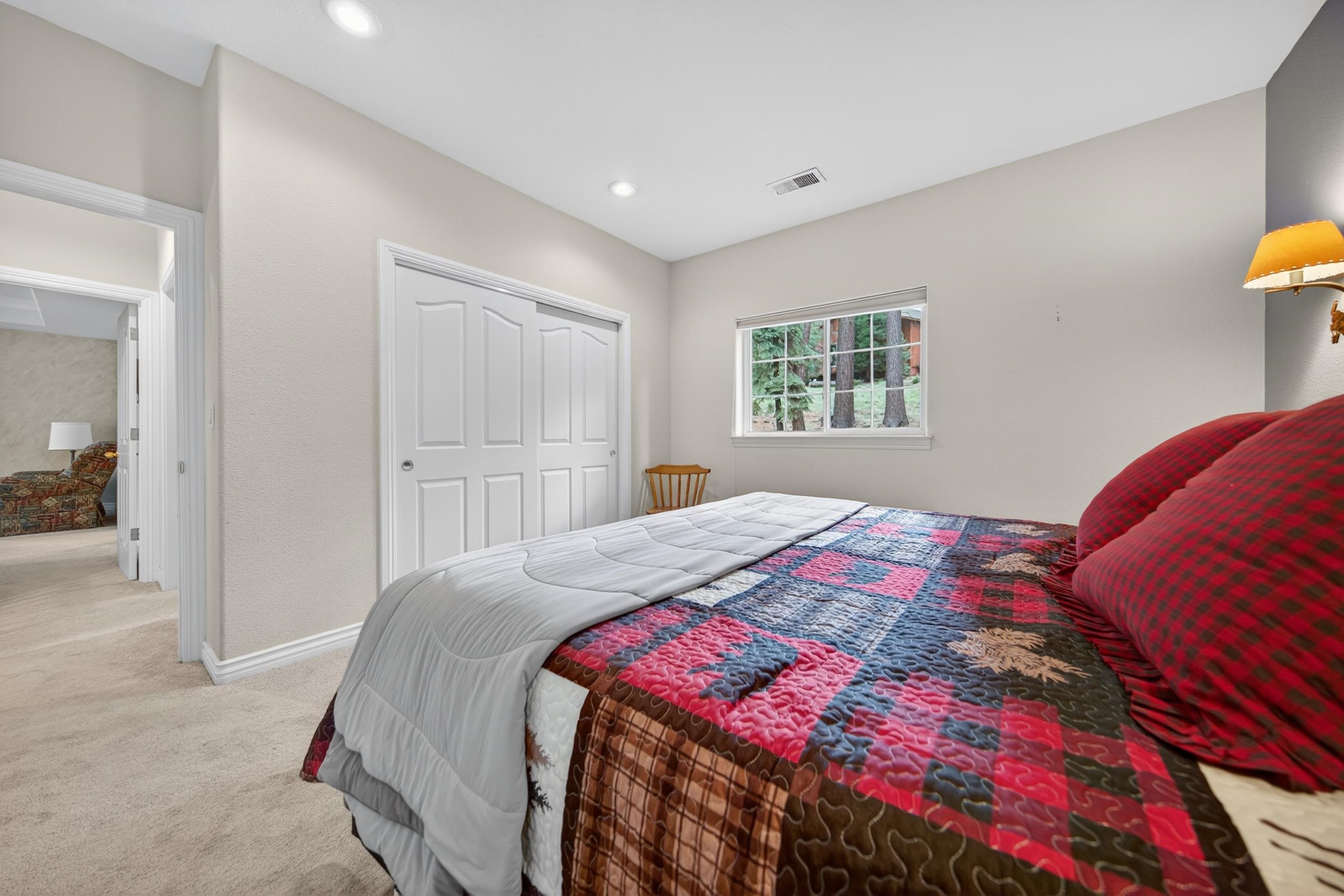 1017 Timber Ridge Road Lake Almanor, CA 96137 - Photo 22 of 45 a bedroom with a bed and a window