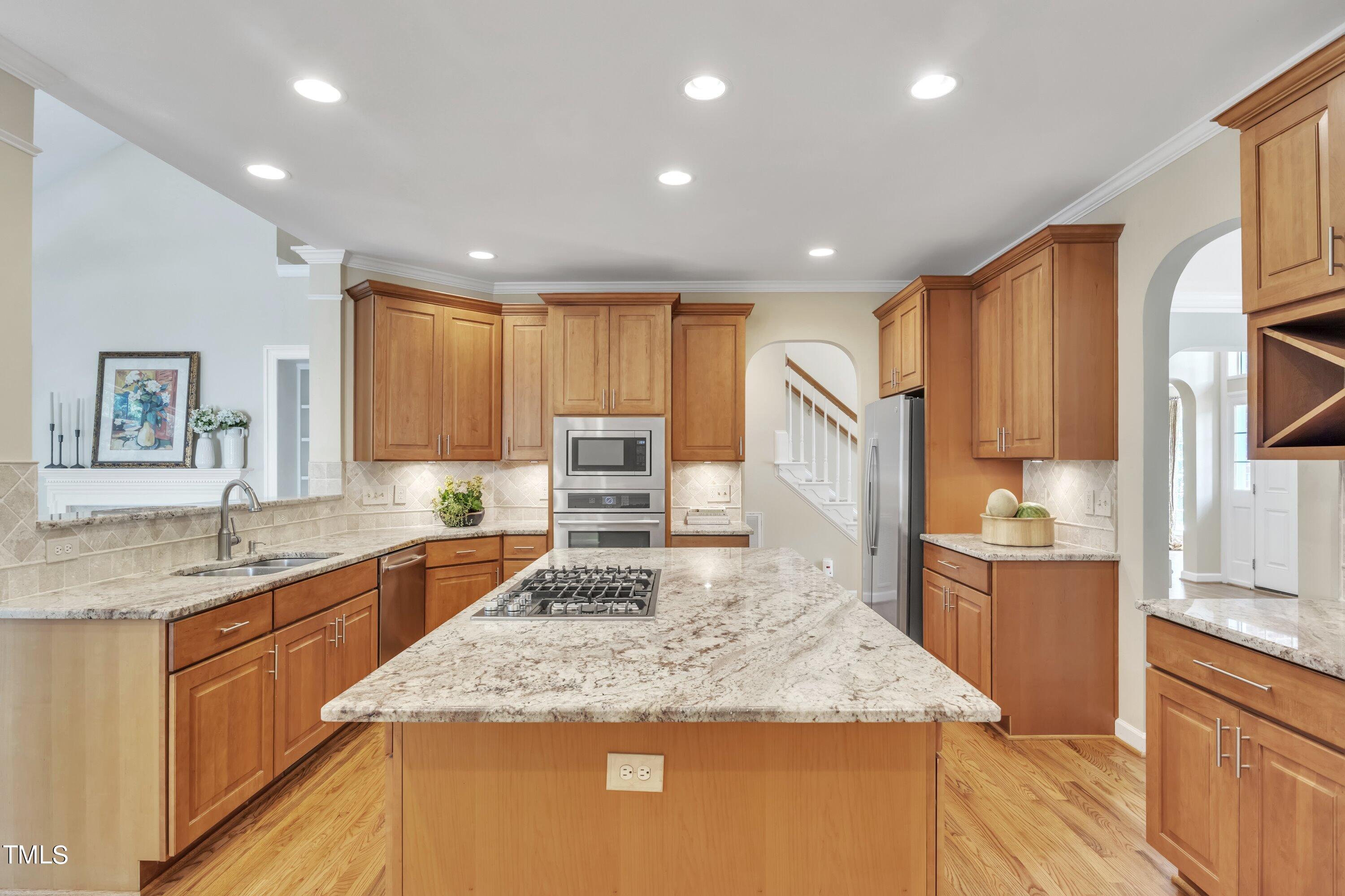 12208 Jasmine Cove Way Raleigh, NC 27614 - Photo 13 of 57 a kitchen with stainless steel appliances granite countertop sink stove and refrigerator
