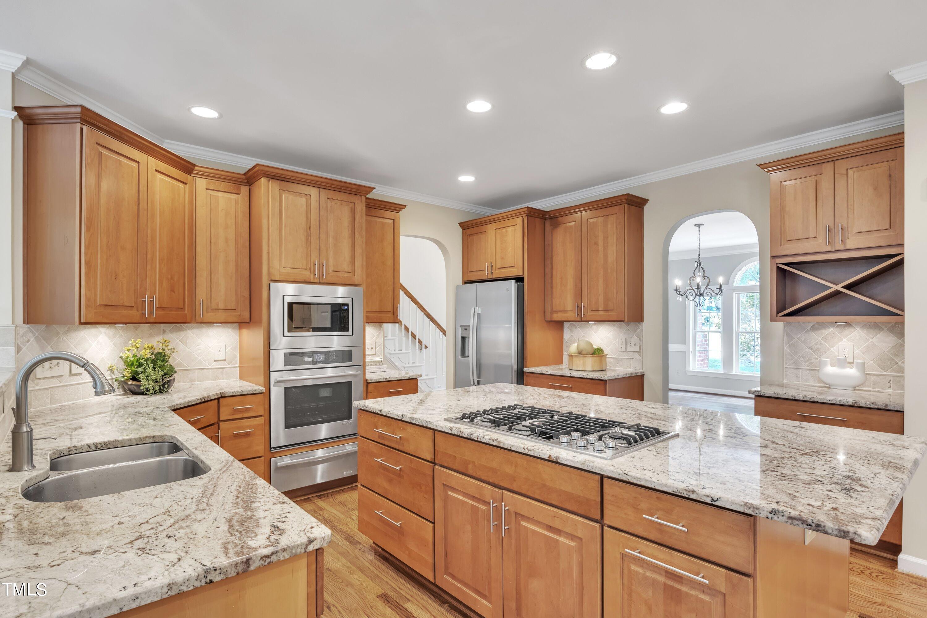 12208 Jasmine Cove Way Raleigh, NC 27614 - Photo 14 of 57 a kitchen with stainless steel appliances granite countertop a sink stove and cabinets