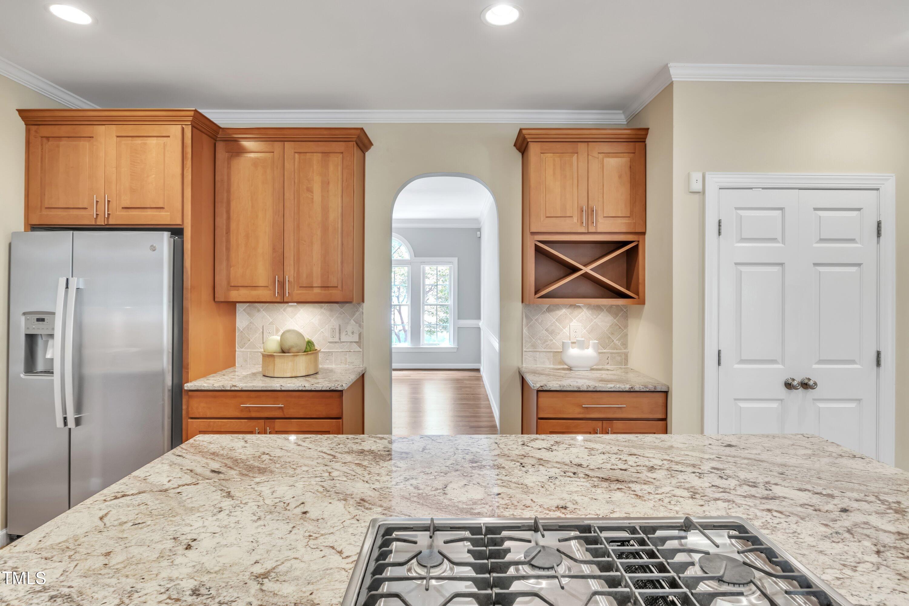 12208 Jasmine Cove Way Raleigh, NC 27614 - Photo 16 of 57 a kitchen with stainless steel appliances granite countertop a refrigerator and a stove top oven