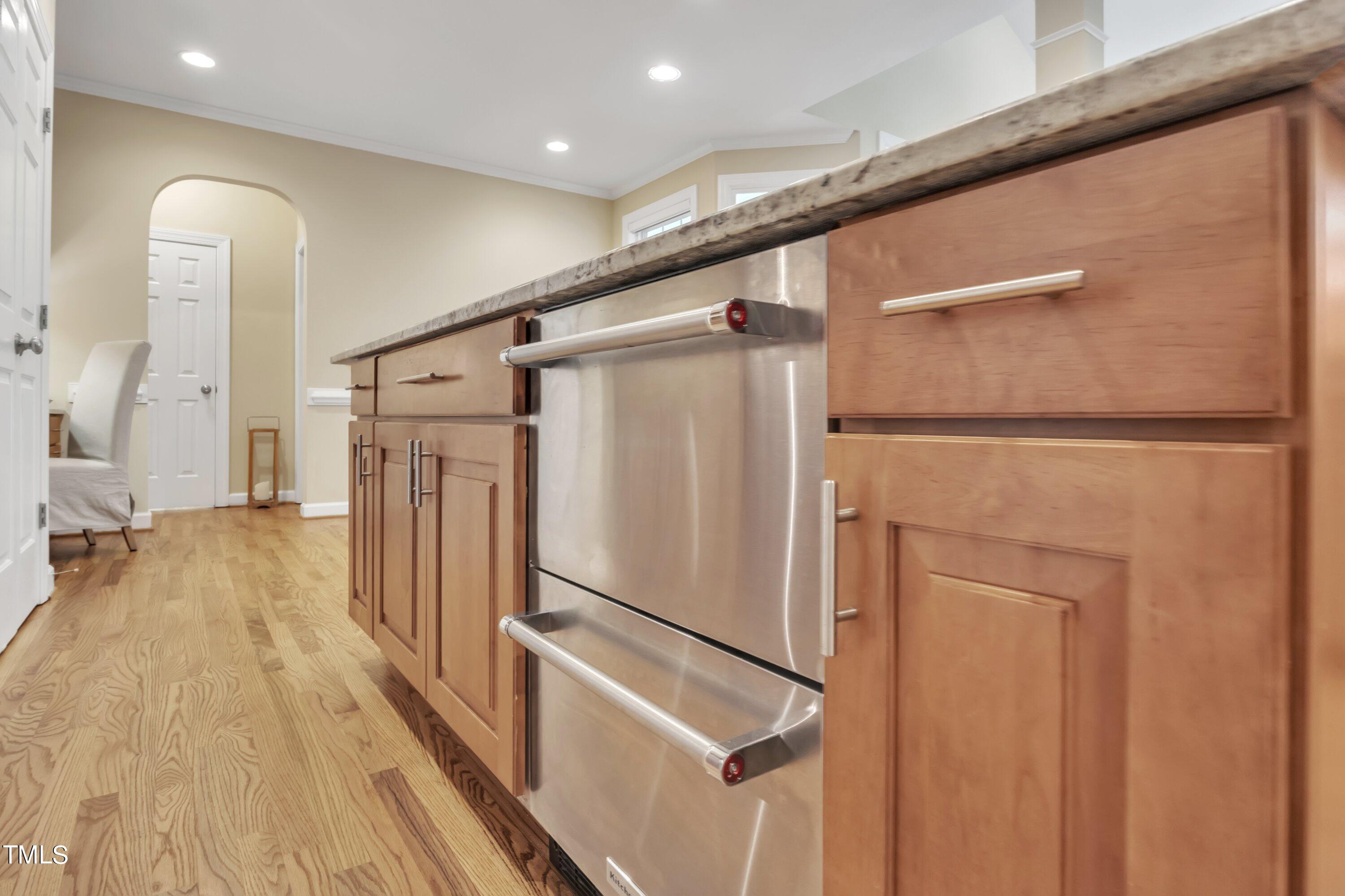 12208 Jasmine Cove Way Raleigh, NC 27614 - Photo 19 of 57 a view of a refrigerator in kitchen and wooden floor