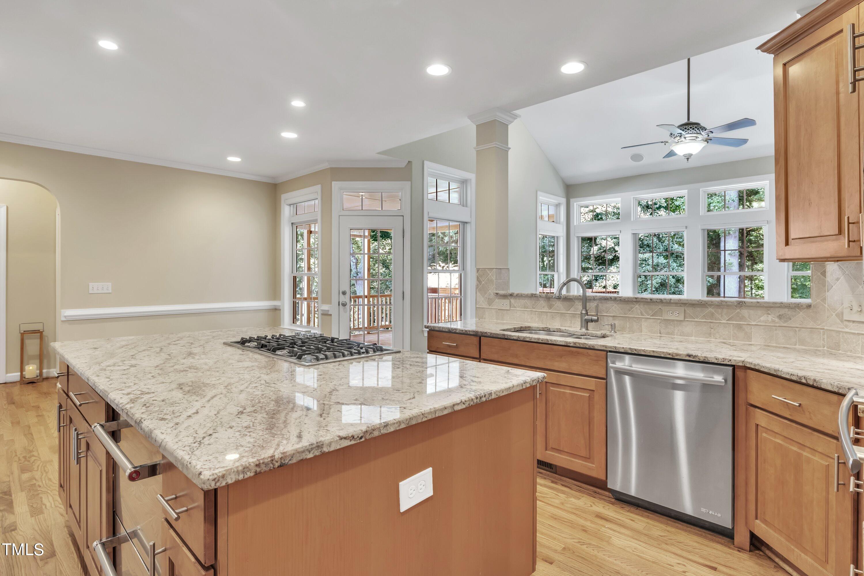12208 Jasmine Cove Way Raleigh, NC 27614 - Photo 20 of 57 a kitchen with granite countertop kitchen island a sink appliances and a counter top space
