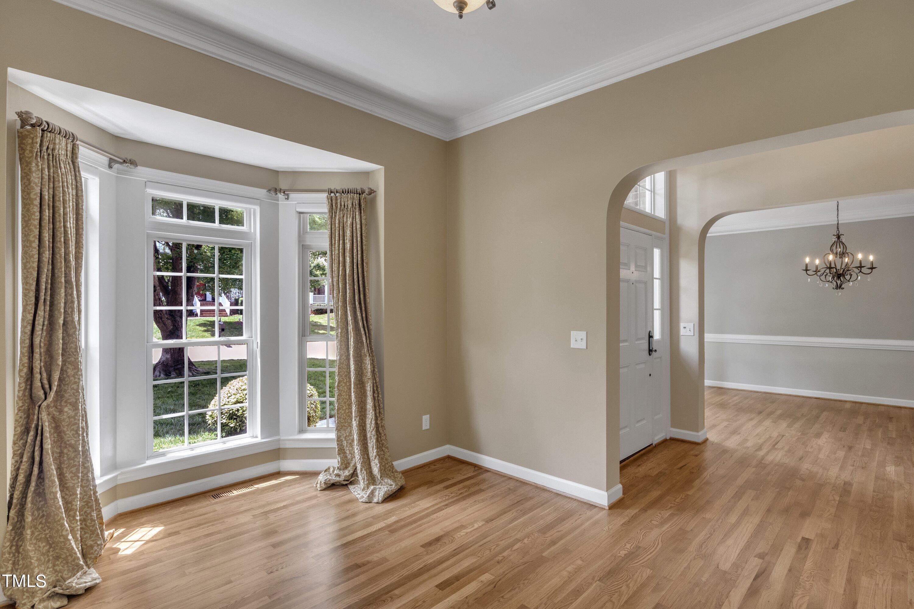 12208 Jasmine Cove Way Raleigh, NC 27614 - Photo 21 of 57 an empty room with wooden floor and windows
